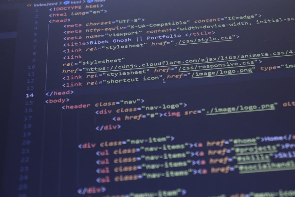 Close-up photograph displaying a computer screen with lines of HTML and CSS code in various colors, including yellow, blue, and red, on a dark background. The code appears to be part of a web developm